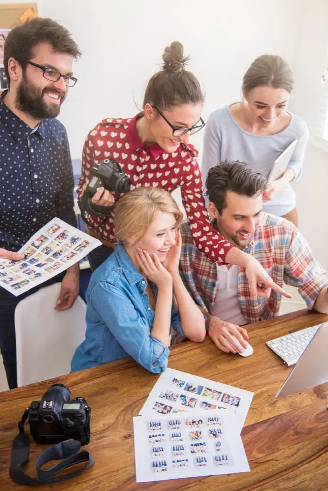Team of marketers reviewing campaign charts, showcasing GroXDigital’s proven results in Facebook advertising.